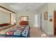 Light-filled bedroom with wood furniture, quilt-covered bed and ensuite bathroom at 4000 Rouse Rd, Orlando, FL 32817