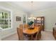 Well-lit dining room with large windows, a wooden table, and a china cabinet, ideal for Gathering dinners at 4000 Rouse Rd, Orlando, FL 32817