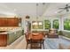 Spacious dining room with large wood table and a view of the natural landscape outside at 4000 Rouse Rd, Orlando, FL 32817