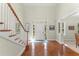 Bright and airy foyer with hardwood floors, a staircase, and a view of the front door and windows at 4000 Rouse Rd, Orlando, FL 32817