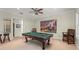 Entertaining game room with a pool table, stools, chairs and a patriotic painting at 4000 Rouse Rd, Orlando, FL 32817
