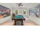 Spacious game room featuring a billiard table, ceiling fan, two windows and neutral color scheme at 4000 Rouse Rd, Orlando, FL 32817