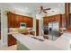 Modern kitchen with stainless steel appliances, counter seating and rich wood cabinetry at 4000 Rouse Rd, Orlando, FL 32817