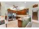 Gourmet kitchen boasts stainless appliances and wood cabinetry, open to breakfast area at 4000 Rouse Rd, Orlando, FL 32817