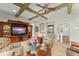 Inviting living room features beamed ceilings and built-in entertainment center at 4000 Rouse Rd, Orlando, FL 32817