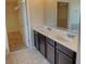 A bathroom with double sinks, tile flooring, walk-in closet, and a large mirror at 4058 Brookshire Cir, Eustis, FL 32736