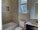 Bathroom featuring tiled shower and tub, a window, and sink at 4058 Brookshire Cir, Eustis, FL 32736