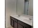 Bathroom featuring a double sink vanity with dark cabinets and a large mirror at 4058 Brookshire Cir, Eustis, FL 32736