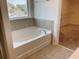 Bathroom with a tub and a large window at 4058 Brookshire Cir, Eustis, FL 32736