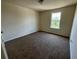 Neutral bedroom featuring a ceiling light and a window offering natural light at 4058 Brookshire Cir, Eustis, FL 32736