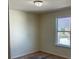 A simple bedroom with carpet and a window overlooking a fenced yard at 4058 Brookshire Cir, Eustis, FL 32736