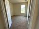 A bright bedroom featuring neutral paint, carpet flooring, and a window providing natural light at 4058 Brookshire Cir, Eustis, FL 32736