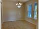 Dining room area with tile floors, a chandelier and two large windows providing natural light at 4058 Brookshire Cir, Eustis, FL 32736