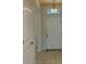 Bright entryway featuring tiled floors, chandelier lighting, and a white front door at 4058 Brookshire Cir, Eustis, FL 32736