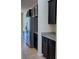Modern kitchen featuring stainless steel appliances and dark cabinetry with light countertops at 4058 Brookshire Cir, Eustis, FL 32736