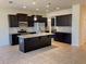 Spacious kitchen with dark cabinets, granite countertops, stainless steel appliances, and large kitchen island at 4058 Brookshire Cir, Eustis, FL 32736