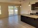 Kitchen island with granite countertop and sink, open to dining area with sliding glass doors at 4058 Brookshire Cir, Eustis, FL 32736