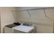 Laundry room featuring a washer, dryer and wire shelving for organized storage at 4058 Brookshire Cir, Eustis, FL 32736