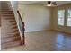 Open-concept living room with tile flooring, stairs, and natural light at 4058 Brookshire Cir, Eustis, FL 32736