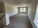 A spacious living room featuring neutral paint, carpet flooring, and several windows for plenty of natural light at 4058 Brookshire Cir, Eustis, FL 32736