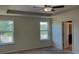 Main bedroom with carpet, tray ceiling, and a closet at 4058 Brookshire Cir, Eustis, FL 32736