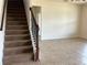 Carpeted staircase with dark wooden railing and decorative wrought iron spindles at 4058 Brookshire Cir, Eustis, FL 32736
