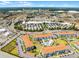 An aerial view of a resort community featuring multiple buildings, a pool, well-manicured grounds, and convenient access to shopping at 43420 Highway 27 # 121, Davenport, FL 33837