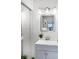 Bright bathroom featuring a modern vanity, stylish lighting fixture, and a square mirror at 43420 Highway 27 # 121, Davenport, FL 33837