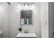 Bright bathroom featuring a modern vanity, stylish lighting fixture, and a square mirror at 43420 Highway 27 # 121, Davenport, FL 33837