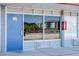 Exterior view displaying the entrance door, windows reflecting nearby structures, showcasing the property's access and surroundings at 43420 Highway 27 # 121, Davenport, FL 33837
