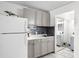 Full kitchen with gray cabinetry, marble countertops, and stainless steel appliances at 43420 Highway 27 # 121, Davenport, FL 33837