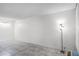 Neutral living space with tile floors, simple decor, and a floor lamp, well-lit by natural light at 43420 Highway 27 # 121, Davenport, FL 33837