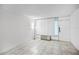 Well-lit living space showcasing tile flooring, a unit air conditioner, and bright white walls at 43420 Highway 27 # 121, Davenport, FL 33837