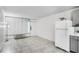 Bright living space with tiled floors, a white refrigerator, and an air conditioning unit, creating a functional area at 43420 Highway 27 # 121, Davenport, FL 33837