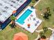 Aerial view of a sparkling community pool with lounge chairs and tables for relaxation under the sun at 43420 Highway 27 # 121, Davenport, FL 33837