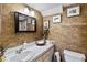 Charming bathroom with decorative walls, traditional vanity with sink, and framed mirror with lighting at 440 Orienta Point St, Altamonte Springs, FL 32701