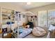 Cozy bedroom with plush beanbag chair, whimsical decor and window with natural light and built-in shelving at 440 Orienta Point St, Altamonte Springs, FL 32701
