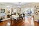 Bright dining room boasts hardwood floors, elegant chandelier, and ample natural light from the adjacent sunroom at 440 Orienta Point St, Altamonte Springs, FL 32701