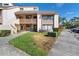 Inviting townhome featuring a balcony, green lawn, and convenient parking at 440 Orienta Point St, Altamonte Springs, FL 32701