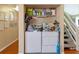 Functional laundry room next to stairs with washer and dryer hookups, and convenient storage solutions at 440 Orienta Point St, Altamonte Springs, FL 32701