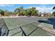 Tennis court surrounded by fencing and mature trees in community at 440 Orienta Point St, Altamonte Springs, FL 32701