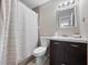 Cozy bathroom featuring a shower with curtain, toilet, and vanity with a dark wood cabinet at 4403 Hector Ct # 3, Orlando, FL 32822