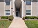 Exterior entrance to condo building with clean walkway, trimmed bushes, and clear building number at 4403 Hector Ct # 3, Orlando, FL 32822