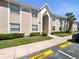 Well-maintained condo exterior with manicured lawn, mature shrubbery, and reserved resident parking at 4403 Hector Ct # 3, Orlando, FL 32822