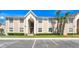 Inviting condo building with lush landscaping, clear blue skies, and well-maintained parking area at 4403 Hector Ct # 3, Orlando, FL 32822