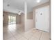 Bright foyer leading into a living space, featuring tile flooring and a view to the balcony at 4403 Hector Ct # 3, Orlando, FL 32822