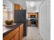 Open kitchen boasts wood cabinets, black appliances, and seamlessly connects to the living area at 4403 Hector Ct # 3, Orlando, FL 32822