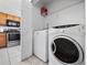 Convenient laundry room features modern washer and dryer units next to kitchen at 4403 Hector Ct # 3, Orlando, FL 32822