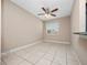 Inviting living room featuring tile flooring, ceiling fan, and a bright window at 4403 Hector Ct # 3, Orlando, FL 32822