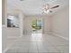 Bright living room featuring tiled floors and sliding glass doors to a balcony at 4403 Hector Ct # 3, Orlando, FL 32822